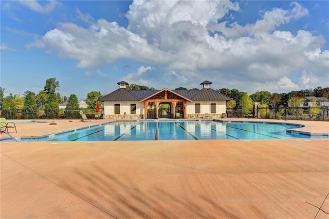 pool featuring a patio and fence