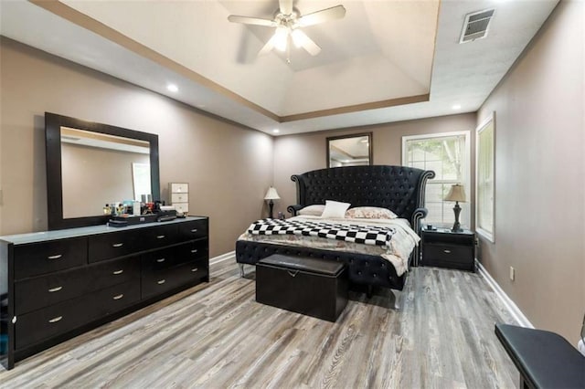 4424 English Loop, Stonecrest, GA 30038 - bedroom featuring light wood-style floors, a tray ceiling, baseboards, and ceiling fan