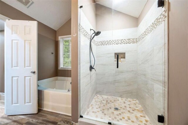 4424 English Loop, Stonecrest, GA 30038 - full bathroom featuring vaulted ceiling, a garden tub, wood finished floors, and a stall shower