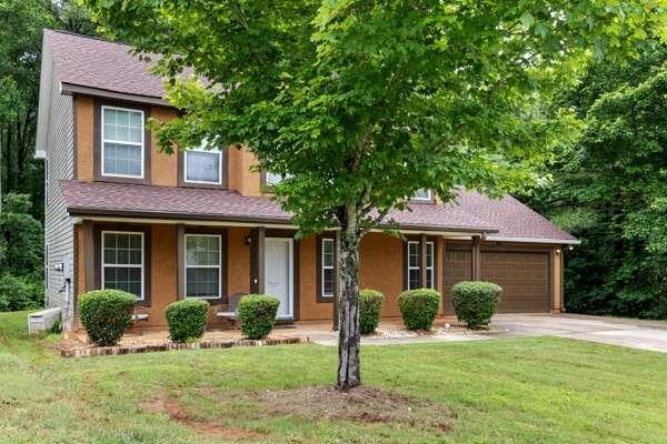 4424 English Loop, Stonecrest, GA 30038 - view of front of house featuring driveway, a garage, a front yard, and a porch