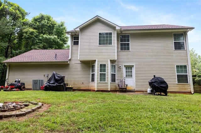 4424 English Loop, Stonecrest, GA 30038 - back of house featuring a fire pit, a yard, and central air condition unit
