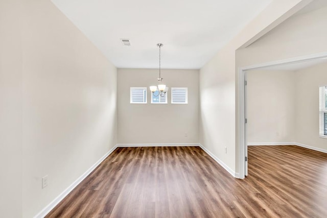 1530 Avalon Creek Rd, Sugar Hill, GA 30518 - spare room with a chandelier, baseboards, and wood finished floors