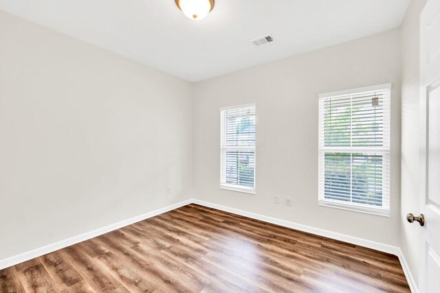 1530 Avalon Creek Rd, Sugar Hill, GA 30518 - empty room with wood finished floors and baseboards