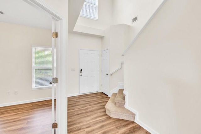 1530 Avalon Creek Rd, Sugar Hill, GA 30518 - entrance foyer with wood finished floors, a towering ceiling, baseboards, and stairs