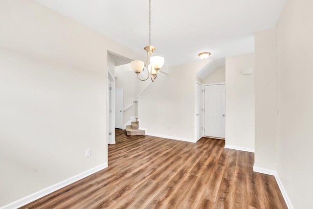 1530 Avalon Creek Rd, Sugar Hill, GA 30518 - unfurnished living room featuring a chandelier, wood finished floors, baseboards, and stairs