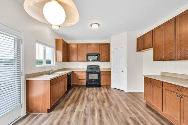 1530 Avalon Creek Rd, Sugar Hill, GA 30518 - kitchen featuring black appliances, brown cabinets, and light wood-type flooring