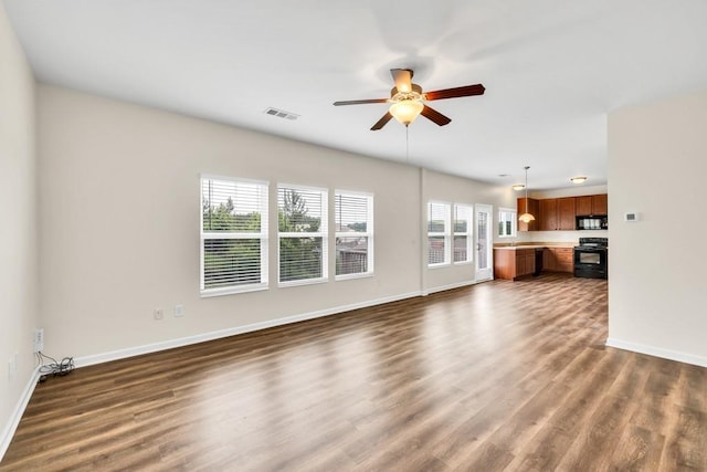 1530 Avalon Creek Rd, Sugar Hill, GA 30518 - unfurnished living room featuring ceiling fan, baseboards, and dark wood finished floors