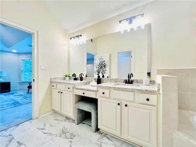 bathroom with lofted ceiling and vanity