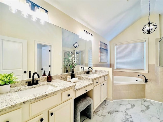 bathroom featuring lofted ceiling, vanity, and independent shower and bath