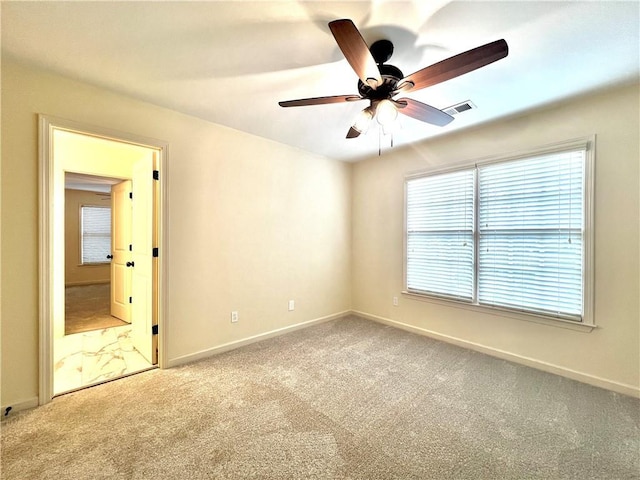 empty room featuring ceiling fan and carpet flooring