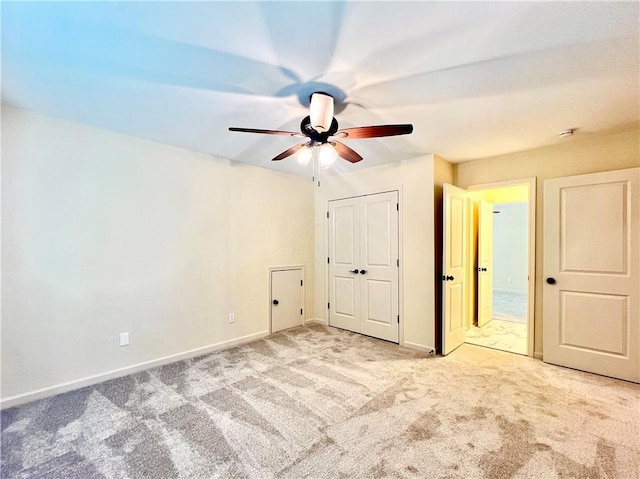 unfurnished bedroom with light colored carpet and ceiling fan