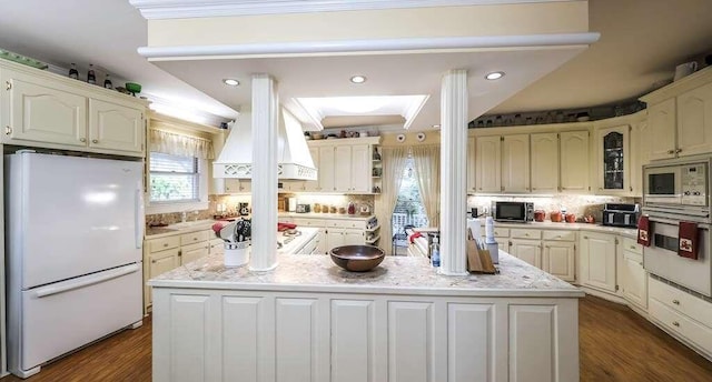 kitchen featuring tasteful backsplash, a kitchen island, stainless steel appliances, and dark hardwood / wood-style floors