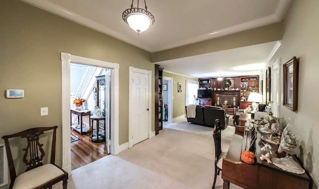 hallway featuring light carpet and ornamental molding