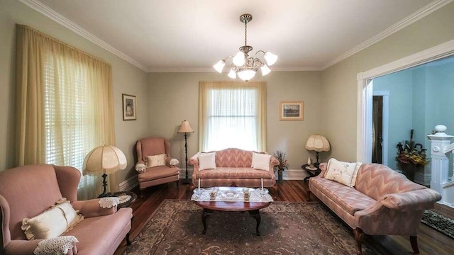 sitting room with dark hardwood / wood-style floors, ornamental molding, and an inviting chandelier