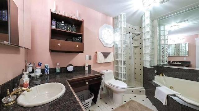 full bathroom featuring plus walk in shower, vanity, tile patterned flooring, and toilet