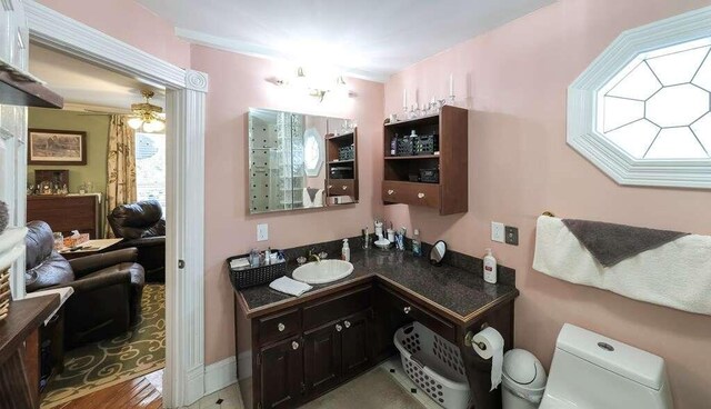 bathroom with ceiling fan, toilet, vanity, and hardwood / wood-style flooring