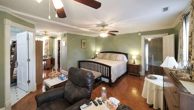 bedroom featuring dark hardwood / wood-style flooring, ceiling fan, and ornamental molding