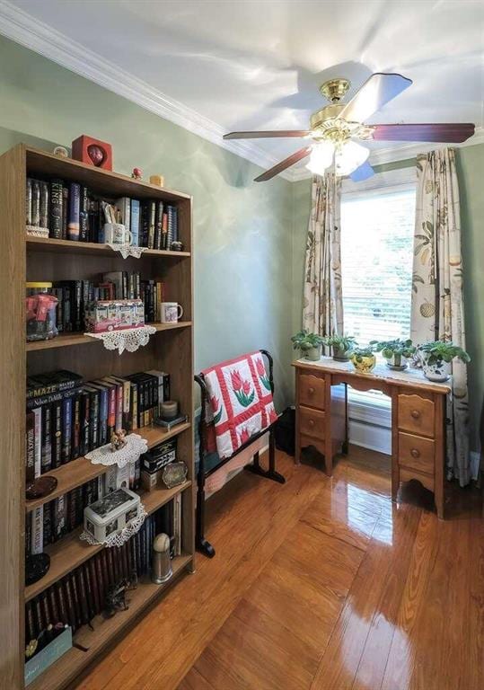 sitting room with crown molding, hardwood / wood-style floors, and ceiling fan