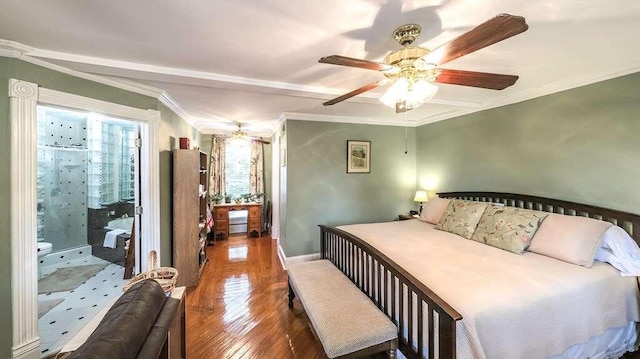 bedroom featuring ceiling fan, ensuite bathroom, dark hardwood / wood-style floors, and ornamental molding