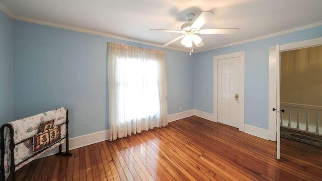 unfurnished bedroom with ceiling fan, hardwood / wood-style floors, and ornamental molding