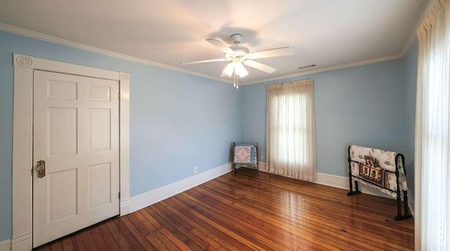 spare room featuring dark hardwood / wood-style flooring, ceiling fan, and ornamental molding