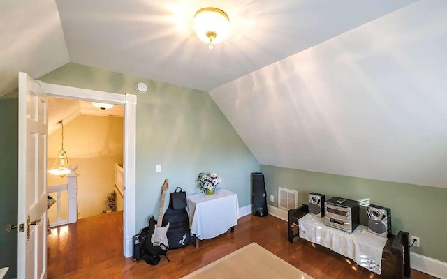 bedroom with dark hardwood / wood-style floors and vaulted ceiling
