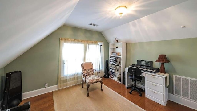 office area with vaulted ceiling and dark wood-type flooring
