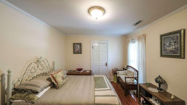 bedroom featuring dark hardwood / wood-style flooring and crown molding