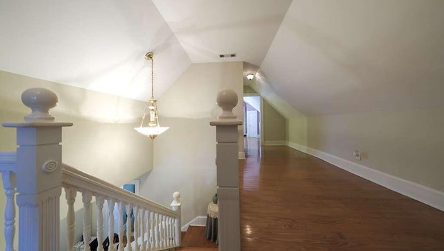 bonus room featuring dark hardwood / wood-style flooring and vaulted ceiling