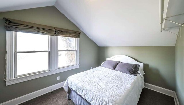 carpeted bedroom featuring vaulted ceiling
