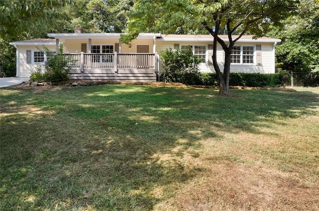 single story home featuring a deck and a front lawn