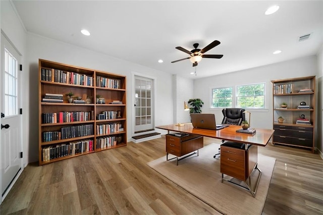 home office featuring ceiling fan and light hardwood / wood-style floors