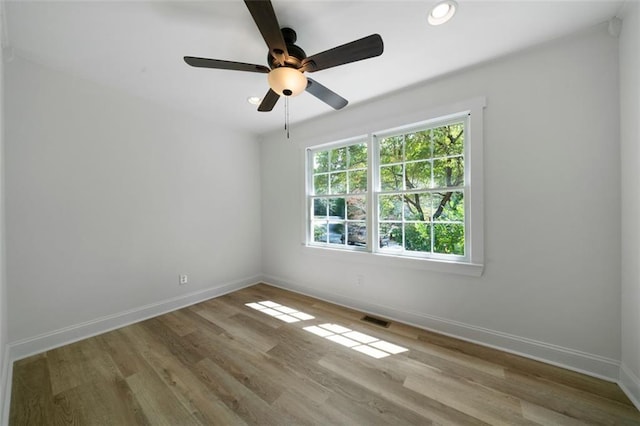 unfurnished room with light wood-type flooring and ceiling fan