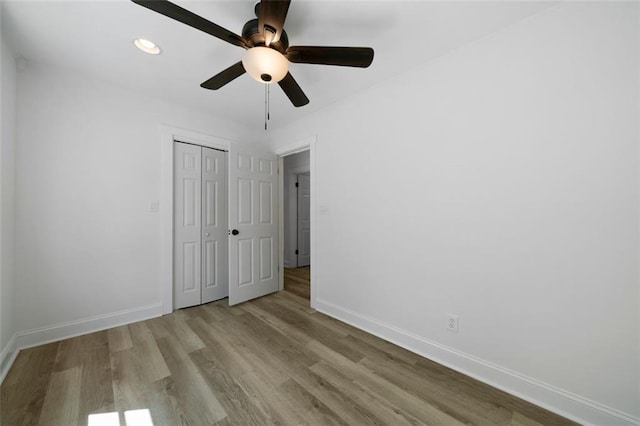 unfurnished bedroom with a closet, ceiling fan, and light hardwood / wood-style floors