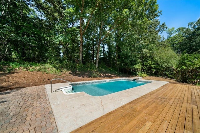 view of swimming pool with a patio and a diving board