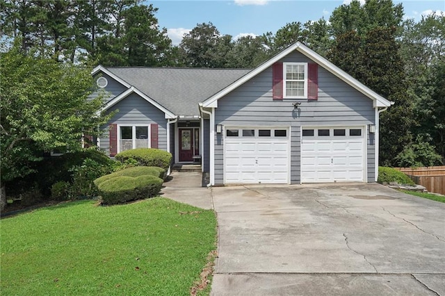 view of front of property featuring a garage and a front lawn