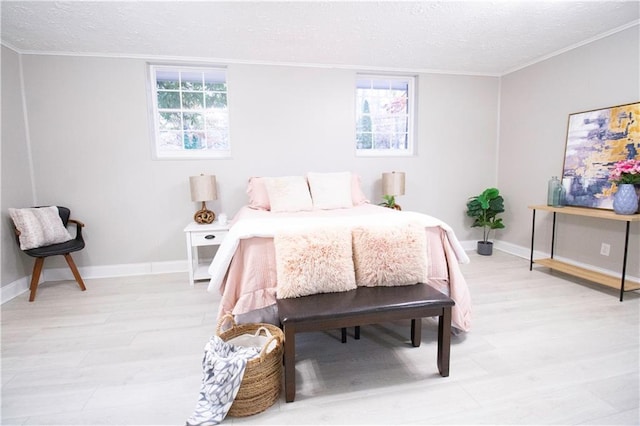 bedroom featuring crown molding, a textured ceiling, and multiple windows