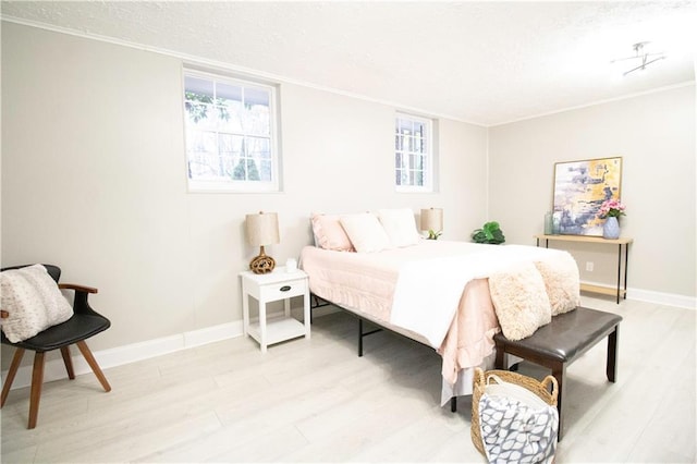 bedroom with light wood-type flooring and multiple windows