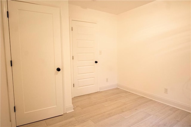 unfurnished room with light wood-type flooring