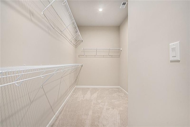 spacious closet with carpet flooring and visible vents