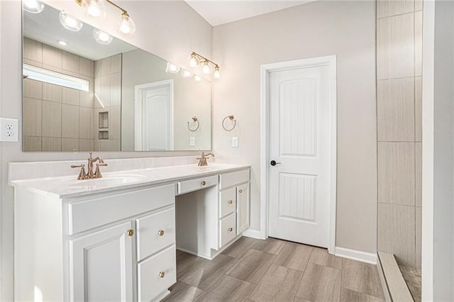 full bathroom with double vanity, wood finished floors, and a sink