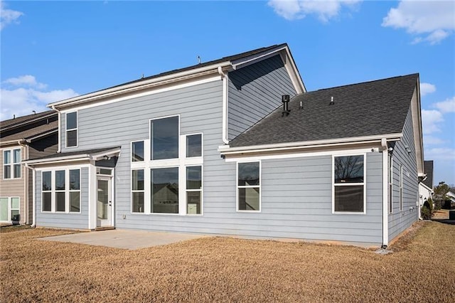 rear view of house featuring a yard and a patio area