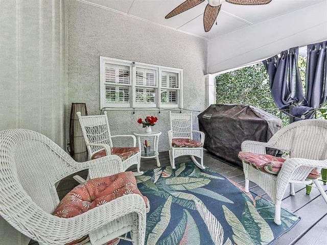 sunroom / solarium with a healthy amount of sunlight and ceiling fan