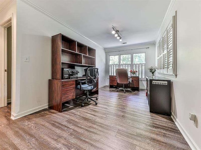 office with rail lighting, baseboards, wood finished floors, and crown molding