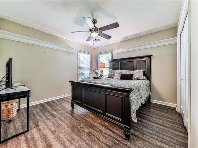 bedroom featuring visible vents, a ceiling fan, baseboards, and wood finished floors