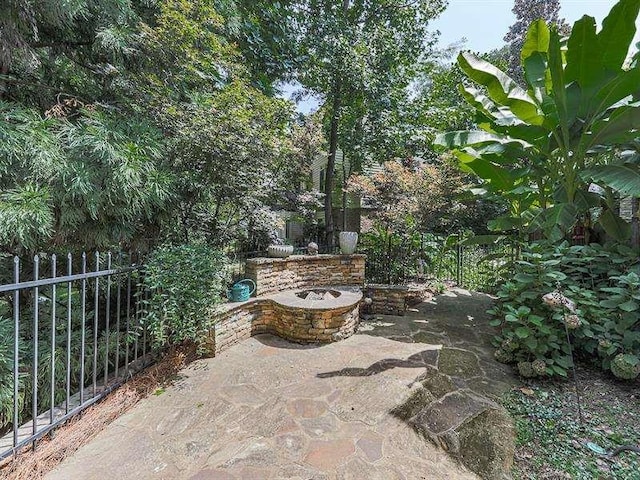 view of patio featuring fence and an outdoor fire pit