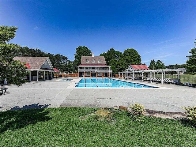 community pool with a patio area, a pergola, and a hot tub