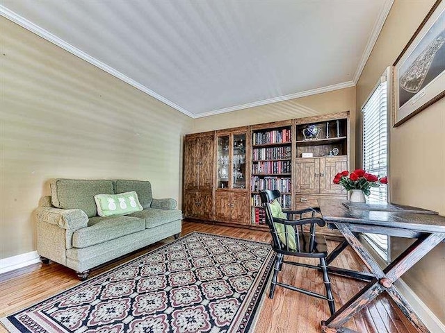 home office featuring baseboards, wood finished floors, and crown molding