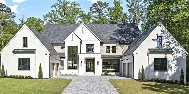 4785 Merlendale Ct, Atlanta, GA 30327 - modern farmhouse featuring decorative driveway, a standing seam roof, a front lawn, board and batten siding, and metal roof