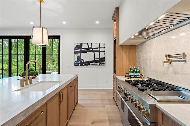4785 Merlendale Ct, Atlanta, GA 30327 - kitchen with a sink, double oven range, wall chimney exhaust hood, light wood-type flooring, and brown cabinets